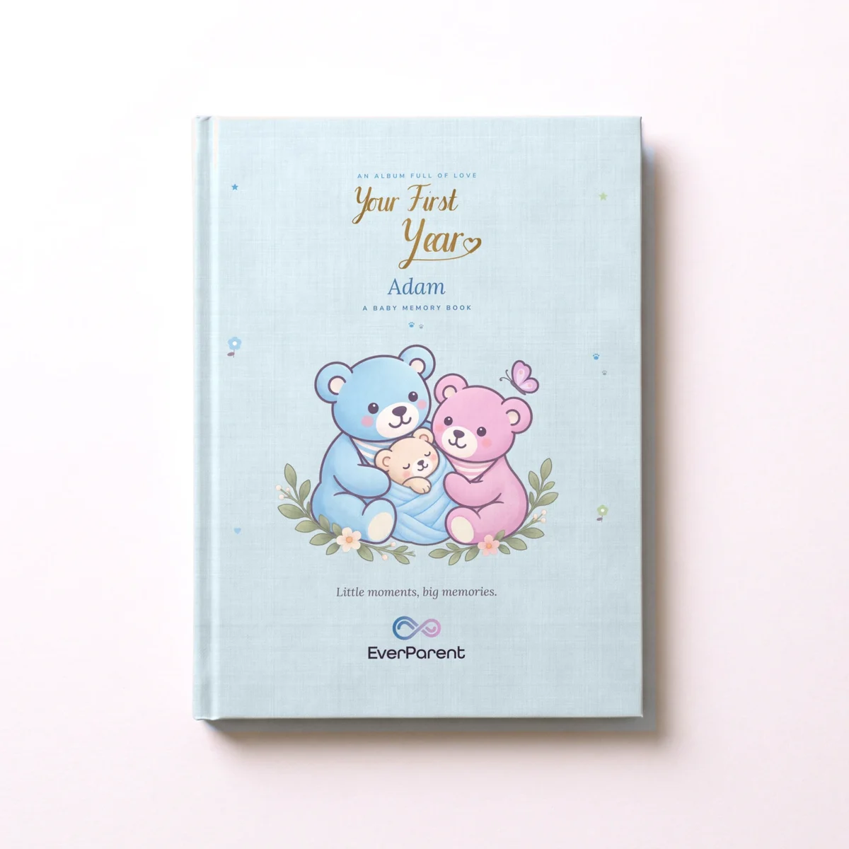 Personalized baby book “Your First Year” in blue with the name Adam on the hardcover, seen from above