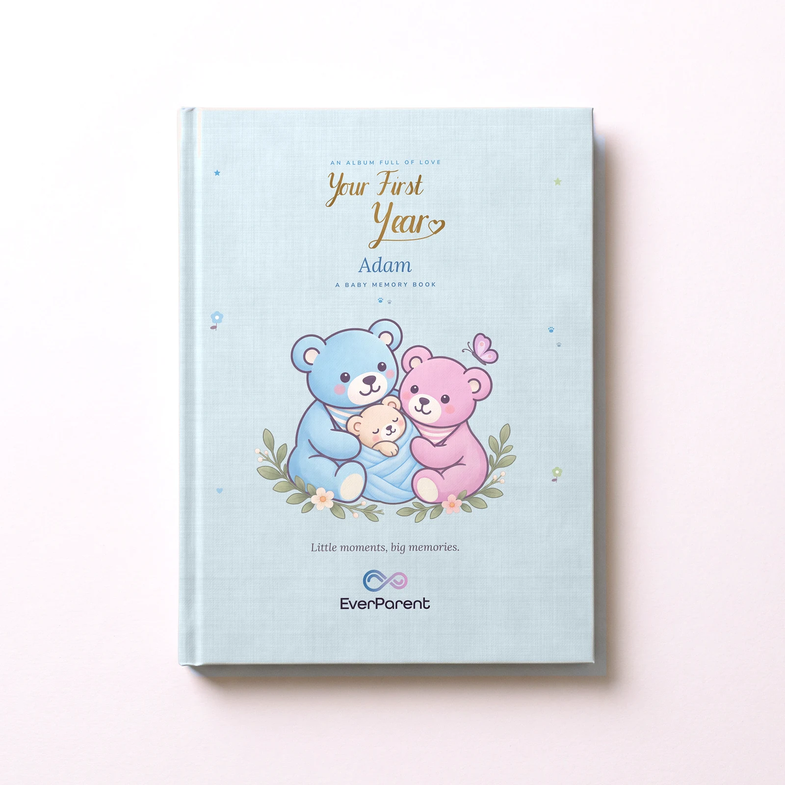 ألبوم ذكريات الطفل «Your First Year» باللون الأزرق باسم Adam على الغلاف المقوى، من الأعلى