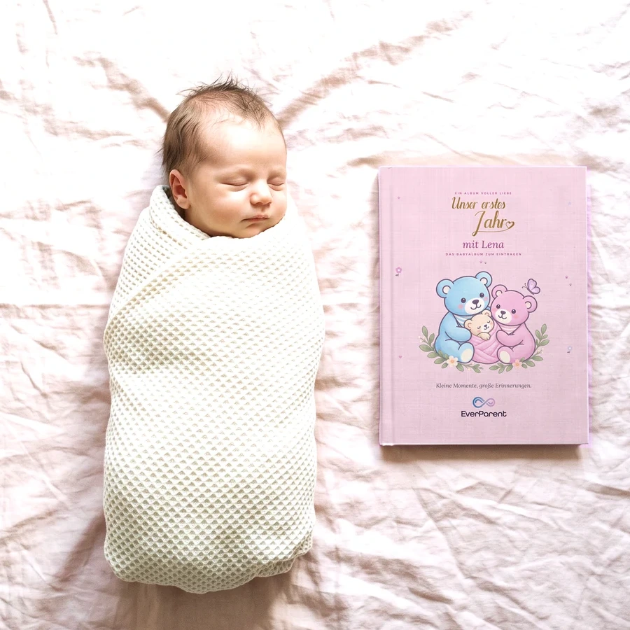 The pink baby book for Lena next to a sleeping baby